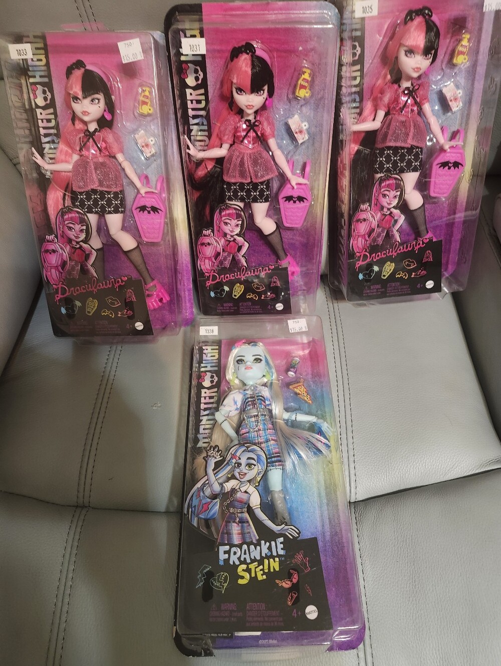 monster high dolls in pink, black and multicolor packaging